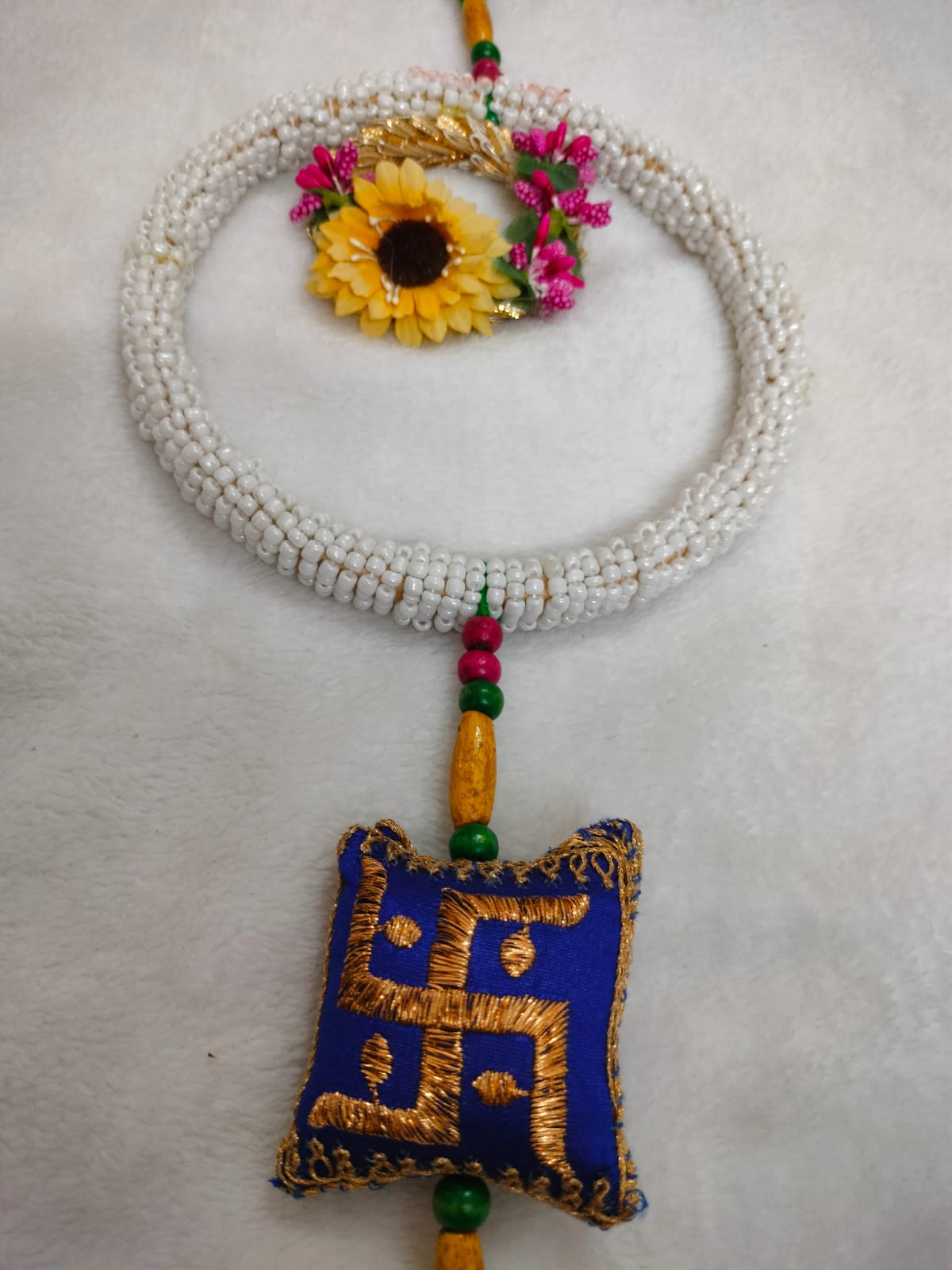 Traditional Beaded Wall Hanging with Swastik and Floral Design